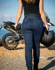 the back of a young woman wearing black t-shirt and blue jeans