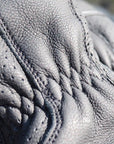 Close-up of a black leather boot with detailed stitching