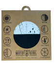 Product packaging for 'Moto Girl' with a half-black, half-white design on a brown cardboard background.