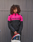 A young woman standing by a motorcycle wearing pink DRIFT motorcycle jacket from Shima