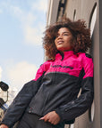 A young woman by a motorcycle wearing pink DRIFT motorcycle jacket from Shima