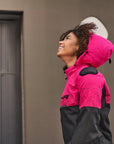 a smiling woman wearing pink DRIFT motorcycle jacket from Shima with a hood