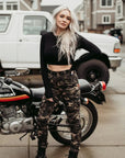 A young blond woman wearing women camouflage motorcycle cargo pants from Moto Girl
