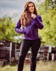 woman standing outside wearing a purple Valerie leather jacket and mc trousers