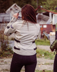 a back of a woman putting sunglasses on and wearing light color women's summer mesh motorcycle jacket from Moto Girl