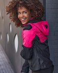A smiling woman wearing pink DRIFT motorcycle jacket from Shima