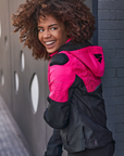 A young afroamerican woman wearing pink motorcycle jacket with the hood