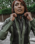 A woman wearing green and black mesh motorcycle jacket and a wind stop jacket