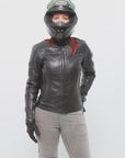 red haired woman wearing a black leather jacket and helmet