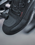 A feet changing motorcycle gear and wearing black and red female motorcycle sneakers from Shima