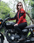 a young woman on a Triumph motorcycle wearing red and black women's motorcycle summer jacket from Moto Girl