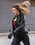 A blond woman wearing Black leather motorcycle jacket for women from Shima