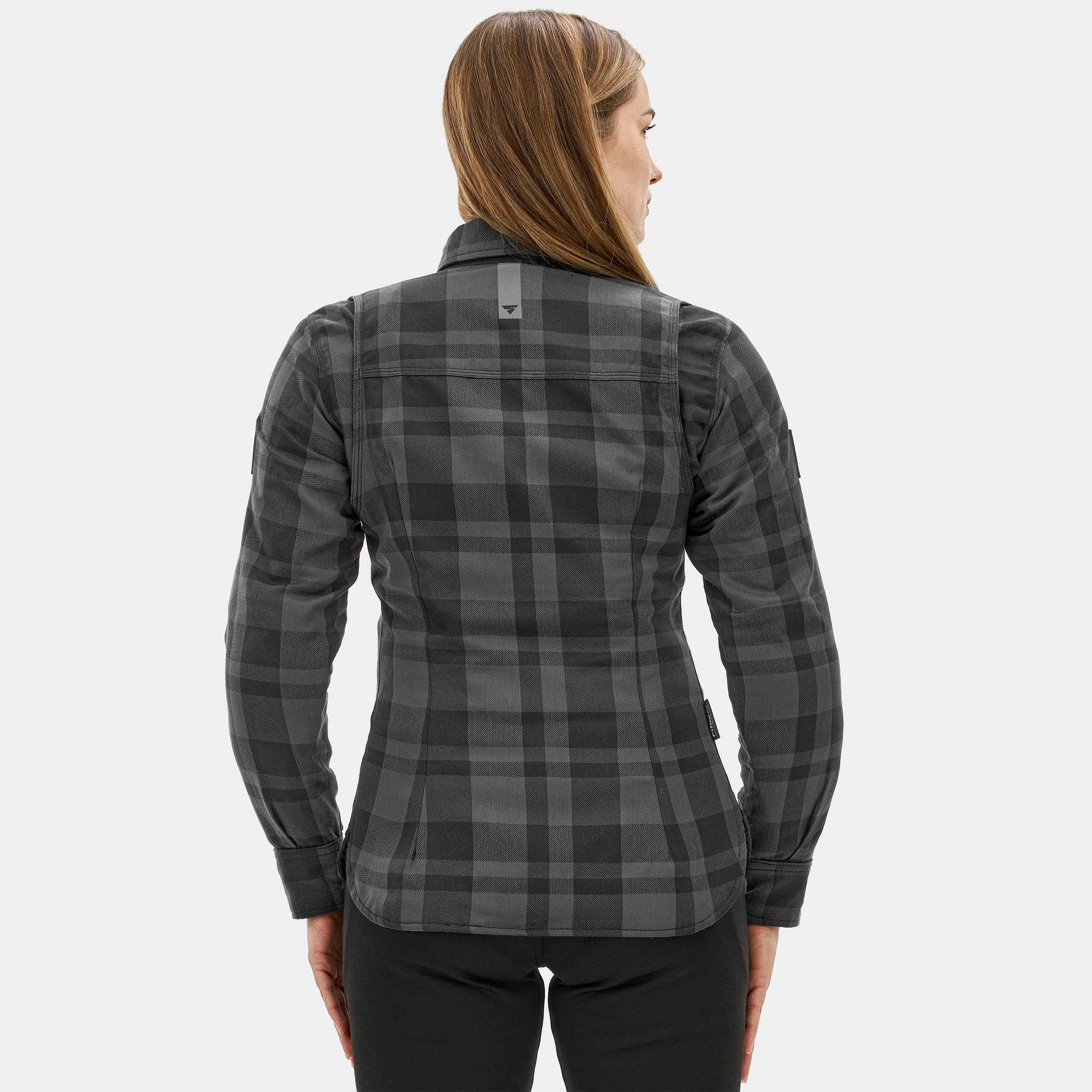 Woman wearing a gray plaid shirt on a white background