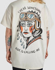 A woman wearing I hear something - ride is calling me motorcycle t-shirt