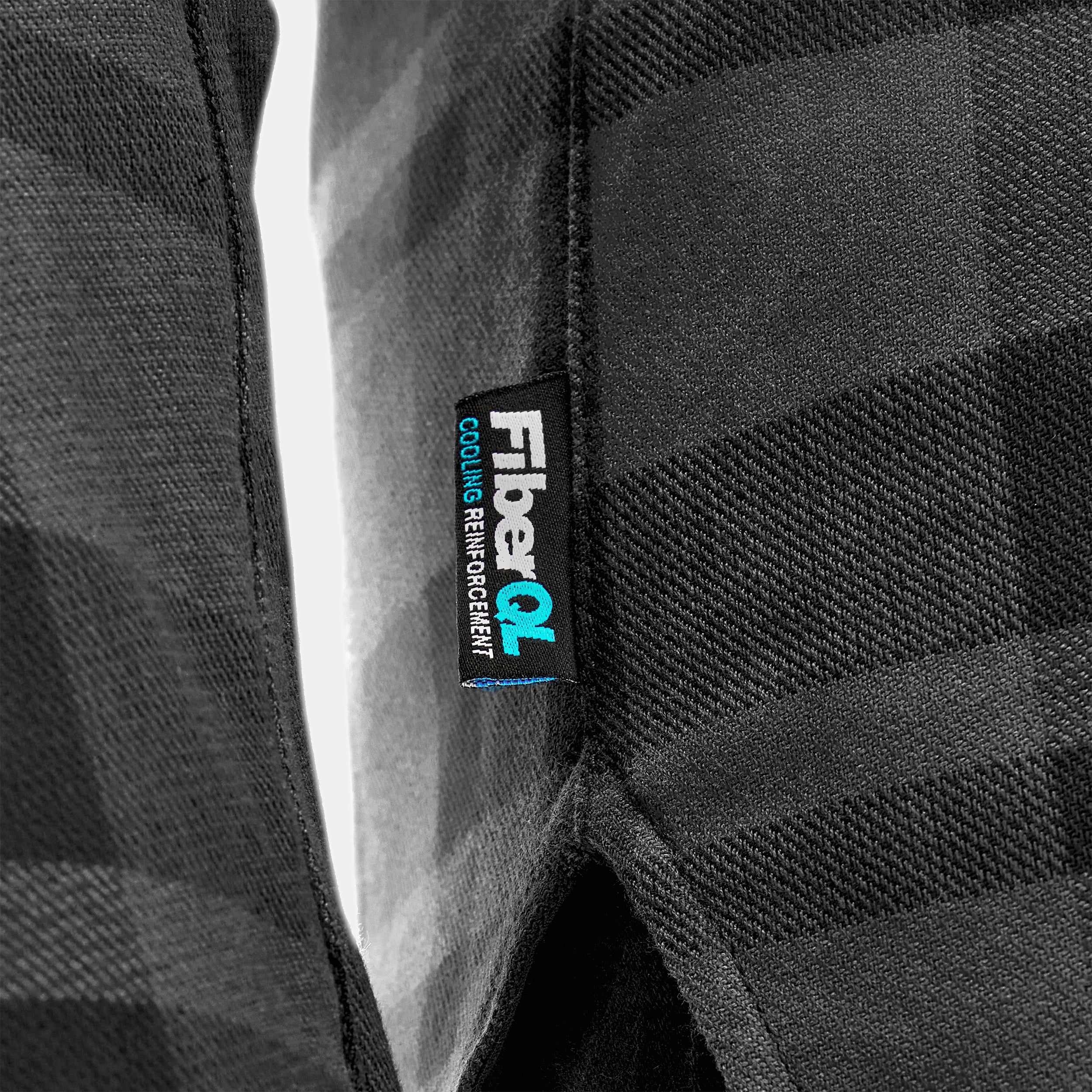 Close-up of a black textured fabric with a 'FiberQ' label.