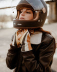 a woman closing her helmet waring colourful leather gloves from WILDUST