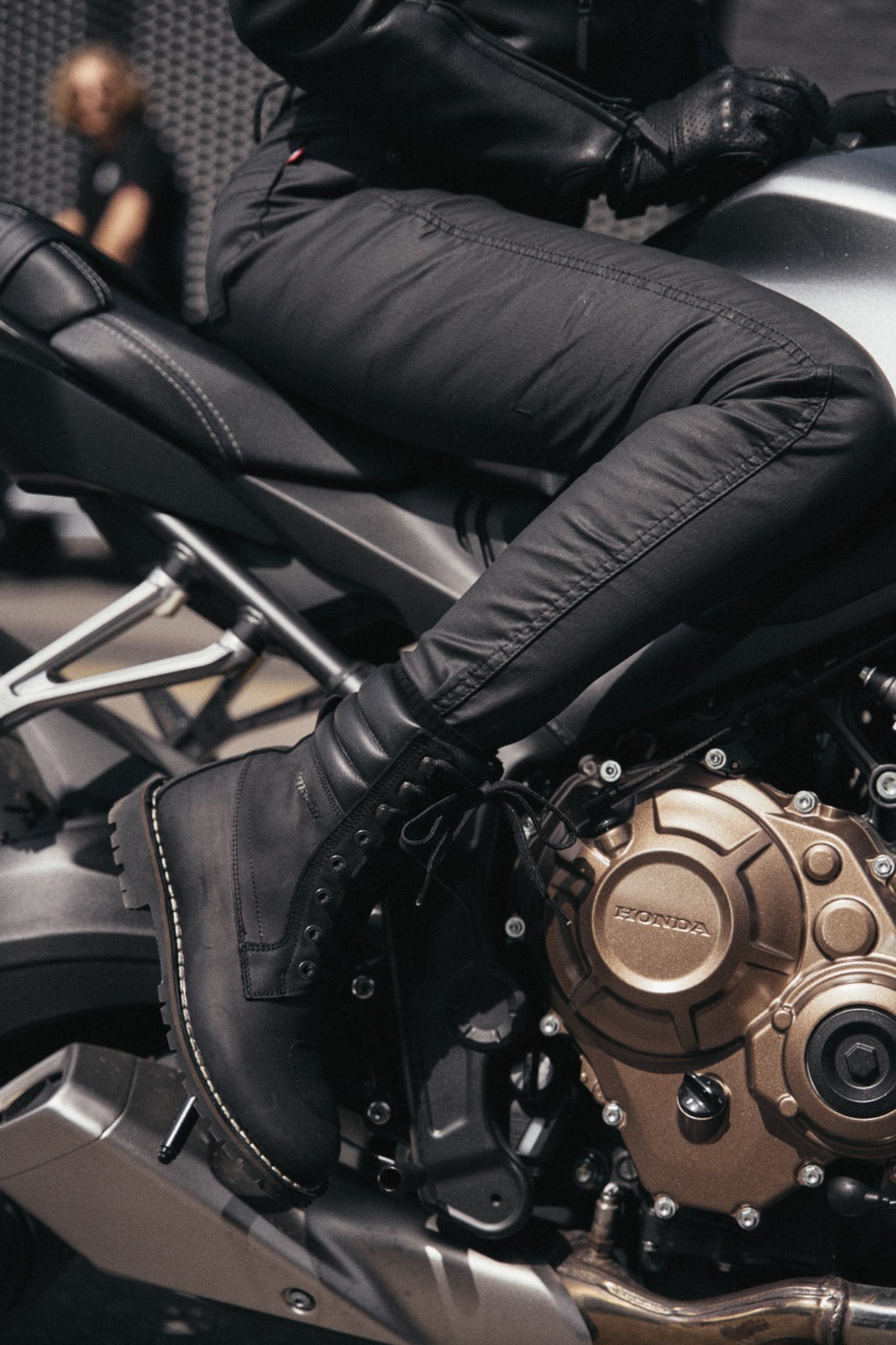 woman's legs on a motorcycle wearing slim-fit motorcycle jeans from Pando Moto 