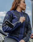 red hair woman leaning on her motorcycle wearing Blue and black women motorcycle mesh jacket from MotoGirl 