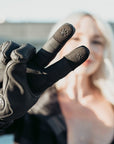 blond woman wearing the Nandi winter gloves from MotoGirl showing her index finger and middle finger with paw detail