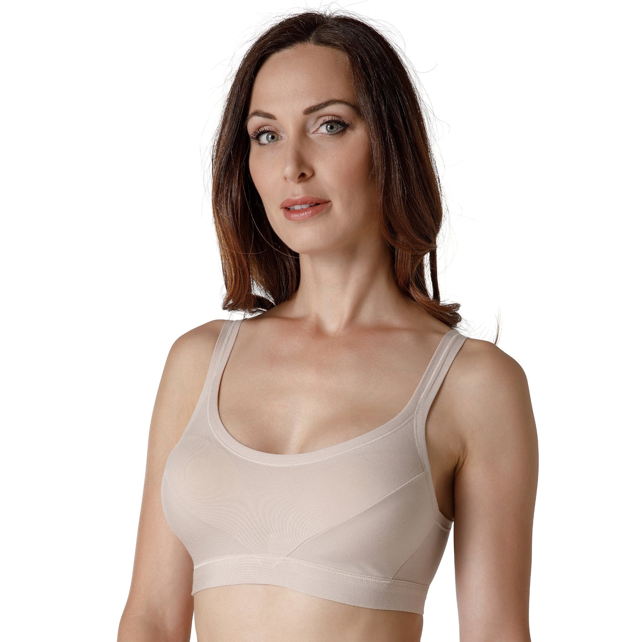 A dark red-haired woman wearing a nude-colored wide-strap bralette from Tramonte.