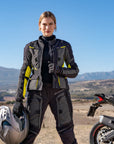 a. woman standing by her motorcycle wearing black fluo motorcycle lady jacket