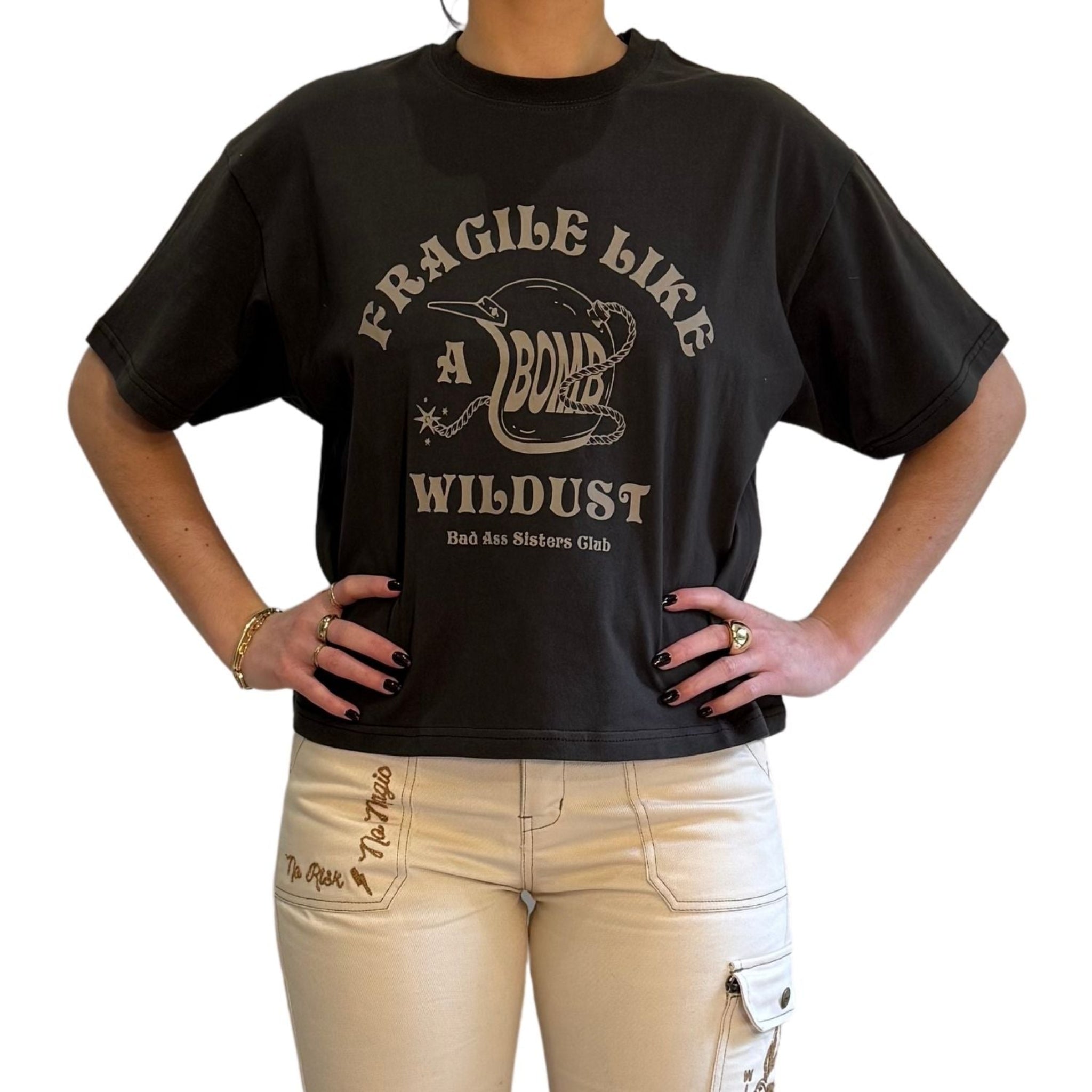 woman demonstarting a off-black wide cut short sleeve women&#39;s motorcycle t-shirt with helmet motive and Fragile like a bomb  logo 