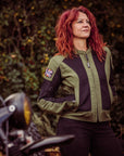 A women standing in front of a motorcycle wearing Women's motorcycle summer mesh jacket in black and green from Moto Girl