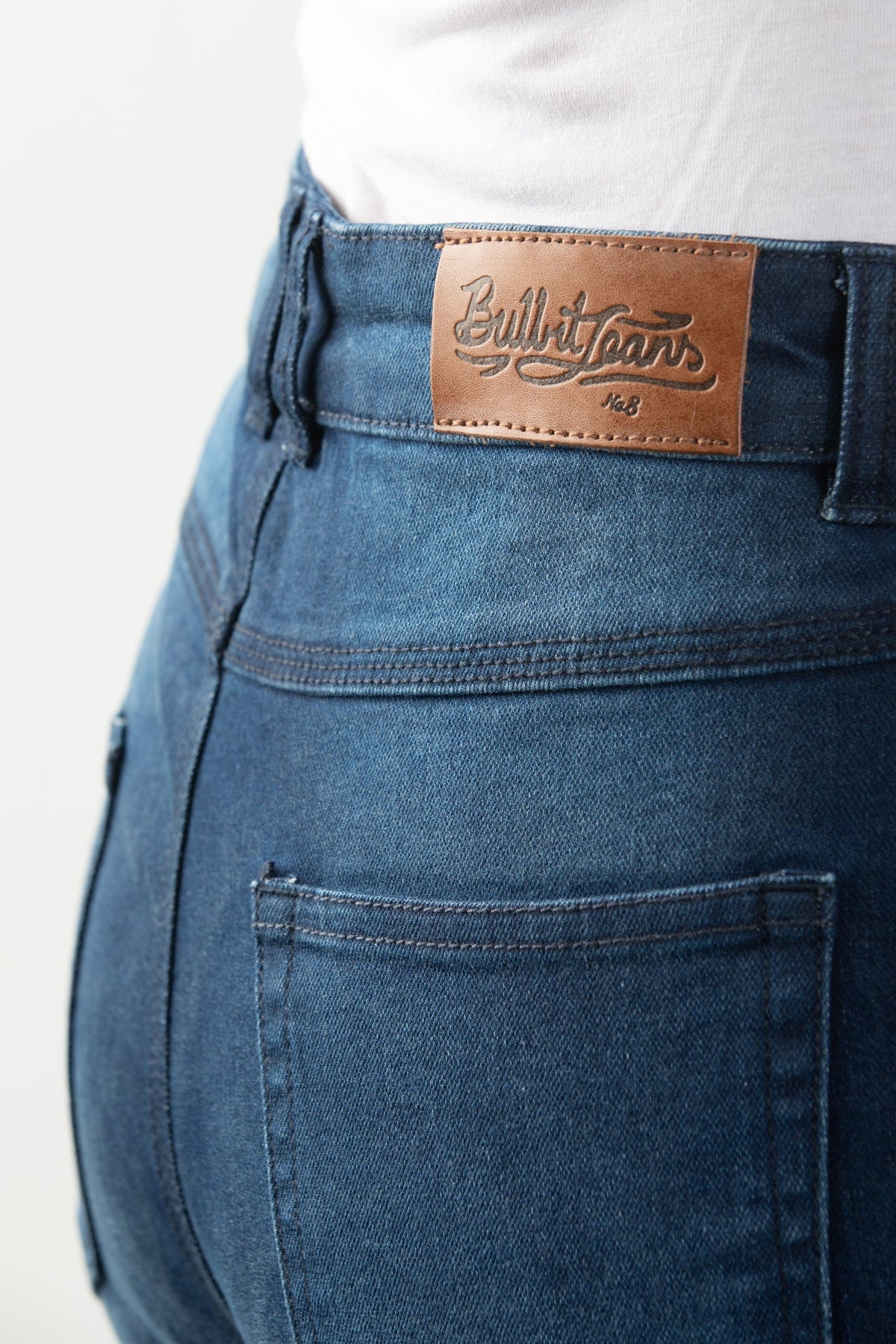Close up of woman's waist wearing lady blue motorcycle jeans