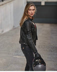 A blond woman wearing Black leather motorcycle jacket for women from Shima