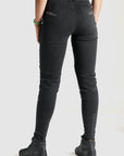 woman's legs  from the back wearing black high waist motorcycle jeans