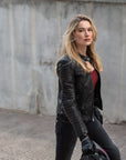 A blond woman  wearing Black leather motorcycle jacket for women from Shima