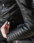 A close up of a stud on the leather motorcycle jacket