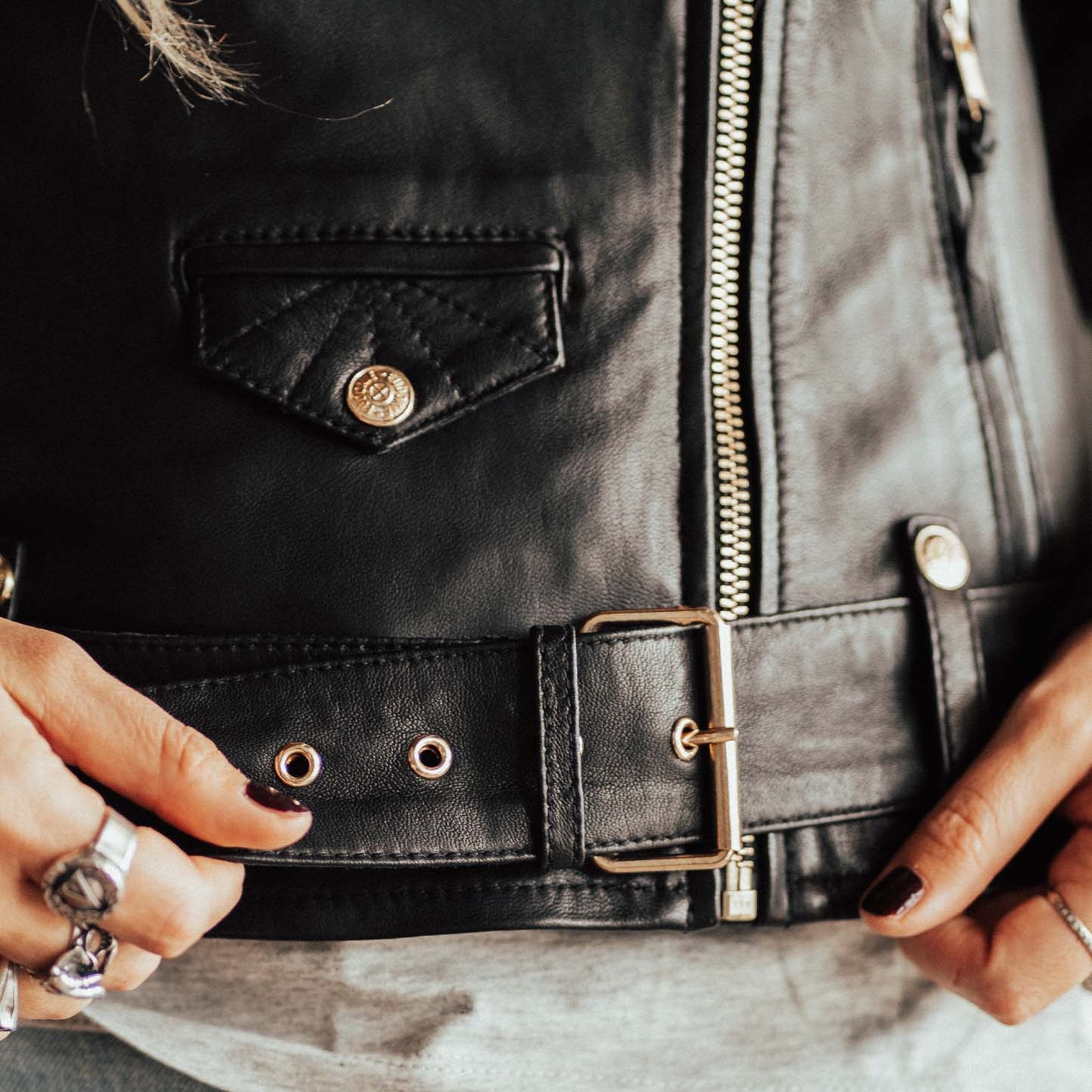 A close up of the belt on the Classic retro black women's motorcycle jacket from Eudoxie