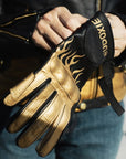 woman's hands putting on a black Eudoxie mc glove with golden flames 