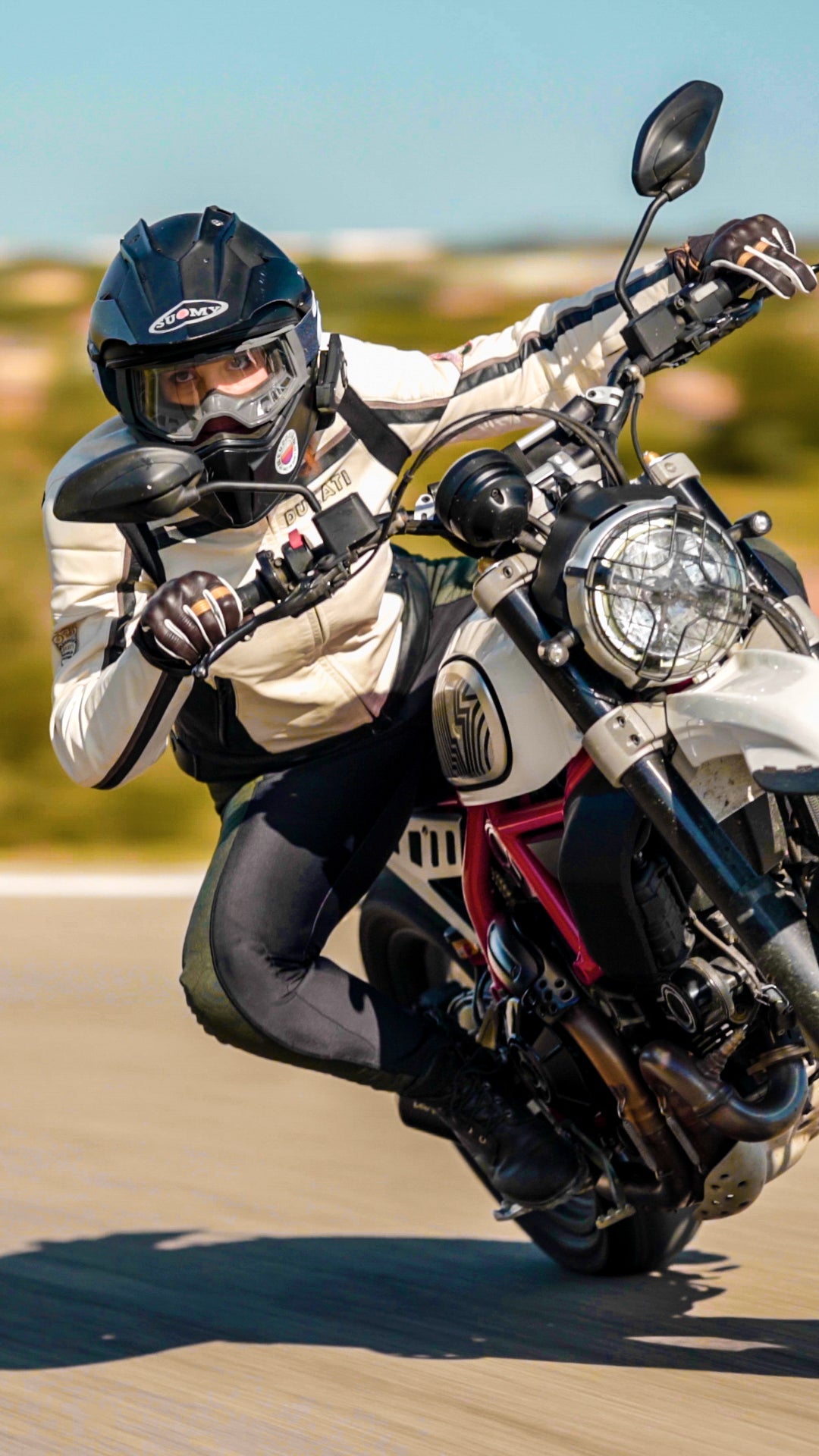 A woman on a motorcycle wearing black and green women's motorcycle leggings from exagon66