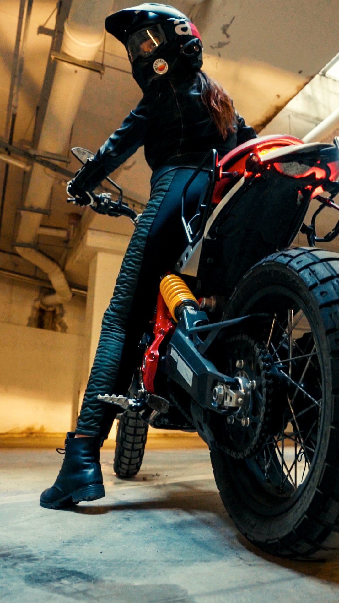 A woman on a motorcycle wearing black and green women's motorcycle leggings from exagon66