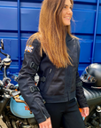 A smiling woman wearing Black summer mesh women's motorcycle jacket with Motogirl patch