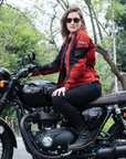 a young woman on a Triumph motorcycle wearing red and black women's motorcycle summer jacket from Moto Girl 